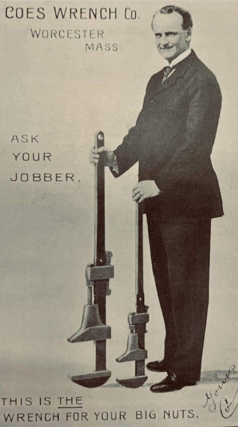 Vintage Coes Wrench Co. advertisement from Worcester, Mass.: a man in a suit stands beside two giant monkey wrenches, with the caption 'This is the wrench for your big nuts.'